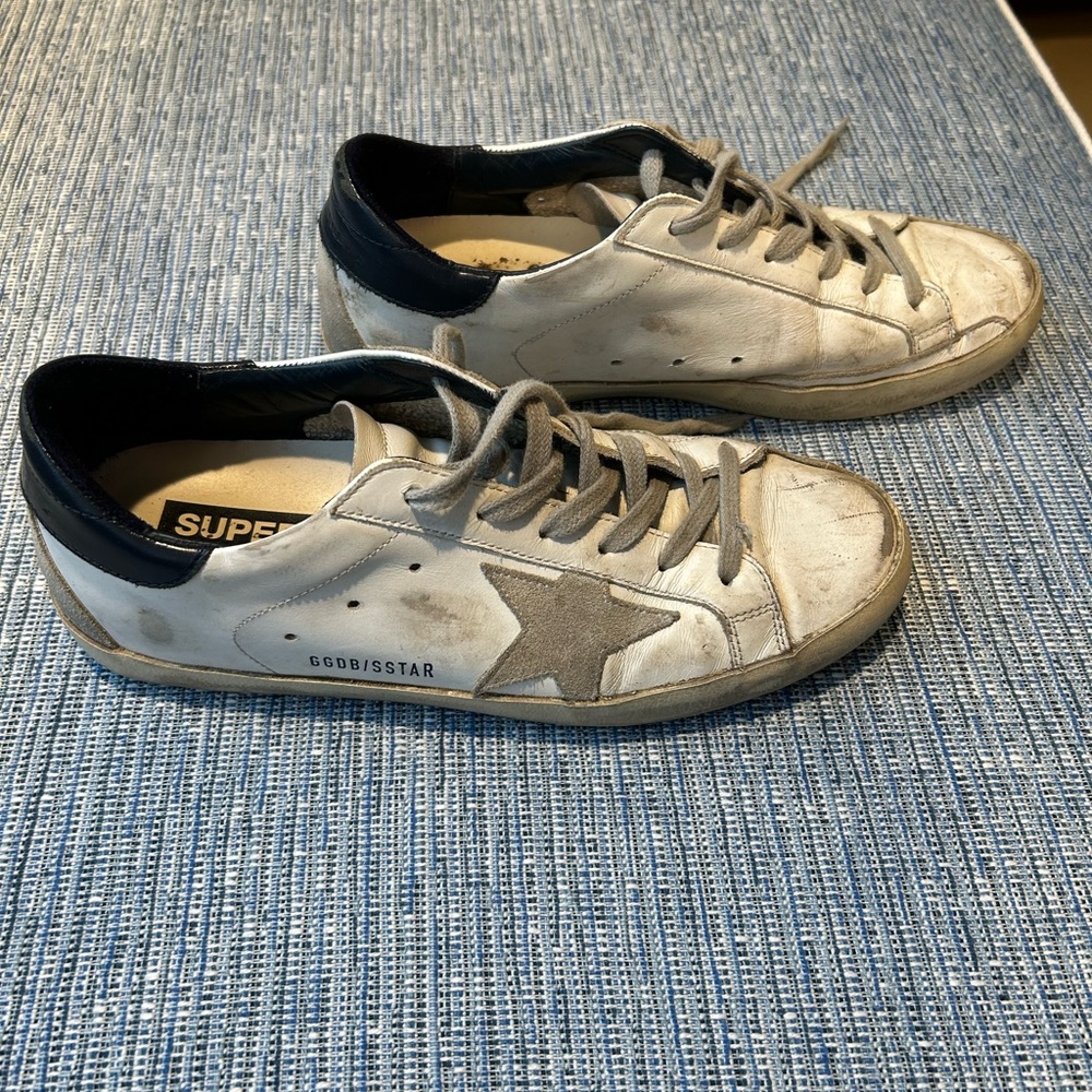 Golden Goose Super Star sneakers with navy trim; size 39.  Sold as is.